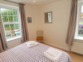 A bedroom with a double bed and a chair at Fair View in St Just in Roseland near St Mawes
