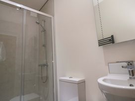 A bathroom with a shower, toilet, and sink at Fair View, St Just in Roseland near St Mawes
