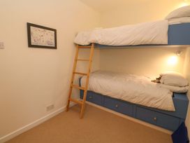 A bedroom with a bunk bed and a ladder at Fair View St Just in Roseland near St Mawes