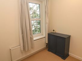 A bedroom with a window and a cabinet at Fair View St Just in Roseland near St Mawes