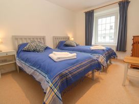 A bedroom with two beds and a window at Fair View in St Just in Roseland near St Mawes