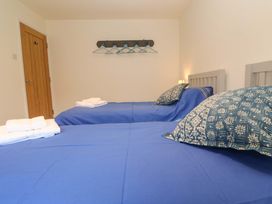 A bedroom with two beds and towels at Fair View in St Just in Roseland near St Mawes
