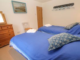 A bedroom with twin beds and a dresser at Fair View in St Just in Roseland near St Mawes