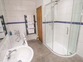 A bathroom with a bathtub and shower at Fair View in St Just in Roseland near St Mawes
