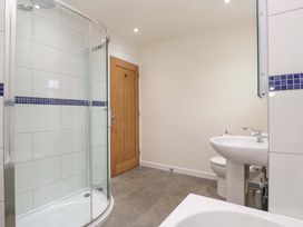 A bathroom with a shower, sink, and toilet at Fair View St Just in Roseland near St Mawes