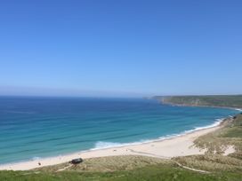 A beach view with sand and ocean at Fair View in St Just in Roseland near St Mawes