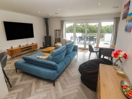 A living room with a sofa and television at Carnon Gwel, Devoran