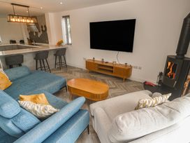 A living room with a sectional sofa and TV at Carnon Gwel, Devoran