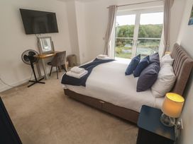 A bedroom with a bed and a desk at Carnon Gwel, Devoran