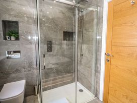 A bathroom with a shower, toilet and sink at Carnon Gwel, Devoran