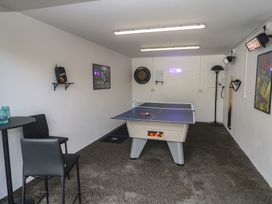 A game room with a table tennis table and dart board at Carnon Gwel, Devoran