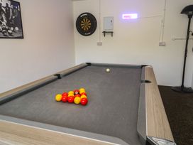 A pool table with balls arranged in a snug at Carnon Gwel, Devoran