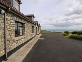 An outdoor area with a stone wall and driveway at Doonalton House, Dromore West, County Sligo