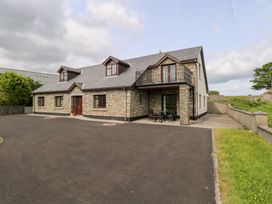 A house with a stone facade and balcony at Doonalton House in Dromore West, County Sligo