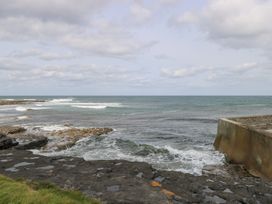 Ocean waves lapping against rocky shore at Doonalton House in Dromore West, County Sligo