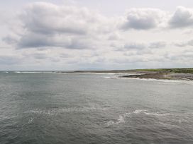 View of the ocean and shoreline with clouds in the sky at Doonalton House Dromore West County Sligo