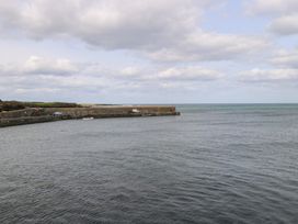 A pier with boats and cars by the water at Doonalton House Dromore West County Sligo