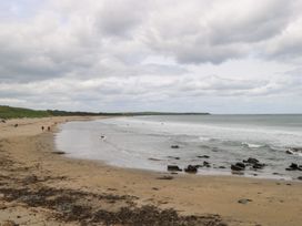A beach view with people walking along the shore at Doonalton House Dromore West County Sligo