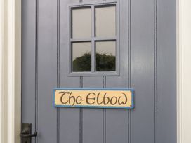 A door with a window and a sign that reads The Elbow at The Elbow in Frampton