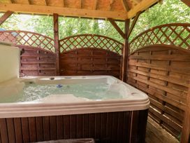 A hot tub enclosed by wooden panels at The Red in Llanerch Park near St Asaph