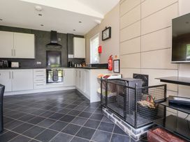 A kitchen with cabinets and an oven at The Fallows in Llanerch Park near St Asaph