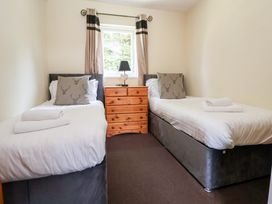 A bedroom with two beds and drawers at The Fallows in Llanerch Park near St Asaph