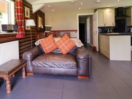 A living room with a sofa and coffee table at The Roe in Llanerch Park near St Asaph