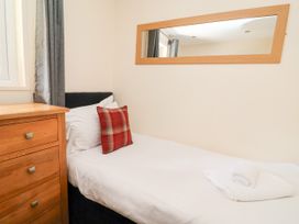 A bedroom with a bed and a bedside table at The Roe in Llanerch Park near St Asaph