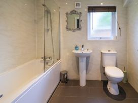 A bathroom with bathtub, sink, and toilet at The Roe in Llanerch Park near St Asaph