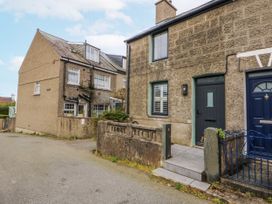Two houses with steps and a gate at East meets West Criccieth