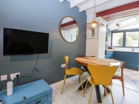 A dining room with a table and chairs at East meets West Criccieth