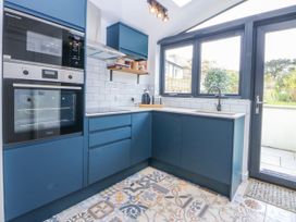 A kitchen featuring a sink and oven at East meets West Criccieth