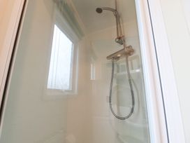 A shower area with a showerhead and a window in a bathroom at Larenzo in Warton Lancashire