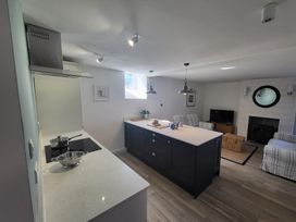 A kitchen with an island and stove at Fishermans Locker in West Bay