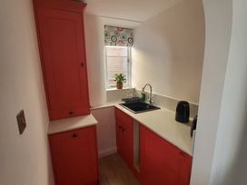 A kitchen with a sink and cupboards at Fishermans Locker in West Bay