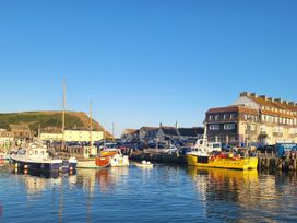A harbor with boats and buildings at Fishermans Locker in West Bay