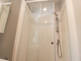 A bathroom with a glass shower enclosure and a handheld shower head at Giorgio Warton Bank near Warton Lancashire