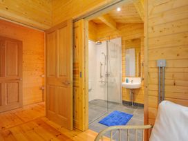 A bathroom with a shower and sink at Owl Lodge Menheniot