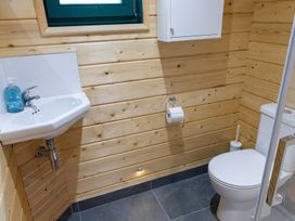 A bathroom with a sink and toilet at Owl Lodge in Menheniot
