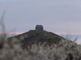 A building on a hill with people walking at Owl Lodge in Menheniot