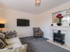 A living room with a sofa and TV at No 8 Burnham-on-Sea