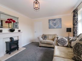 A living room with a sofa and fireplace at No 8 in Burnham-on-Sea