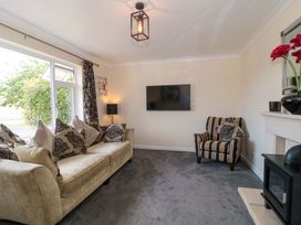 A living room with a sofa and television at No 8 Burnham-on-Sea