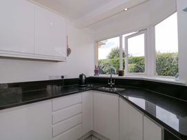 A kitchen with a sink and kettle at No 8 Burnham-on-Sea