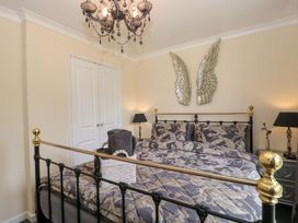 A bedroom with a bed and decorative wings at No 8 in Burnham-on-Sea