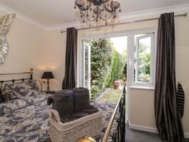 A bedroom with a bed and window leading to the garden at No 8 Burnham-on-Sea