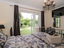 A bedroom with a bed and garden view at No 8 in Burnham-on-Sea