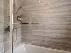 A bathroom with a shower and bathtub at No 8 in Burnham-on-Sea