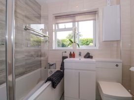 A bathroom with a bathtub and sink at No 8 Burnham-on-Sea