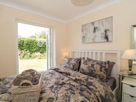 A bedroom with a bed and open door leading to the garden at No 8 Burnham-on-Sea